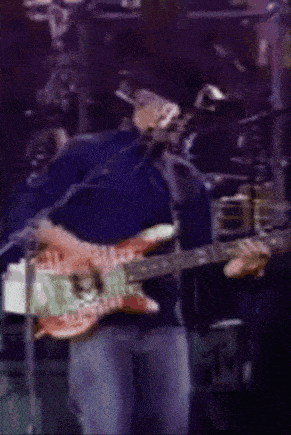 a man in a cowboy hat is playing a guitar
