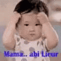 a baby is holding his head with his hands while making a funny face .