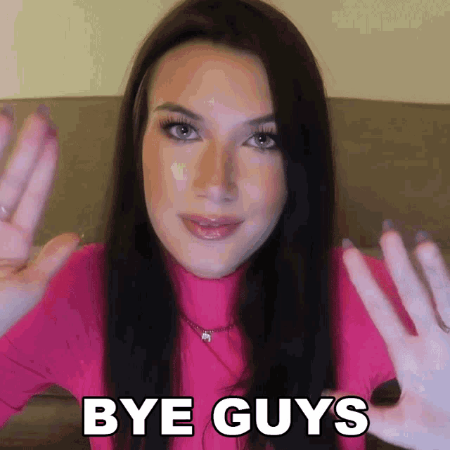 a woman in a pink shirt says bye guys with her hands