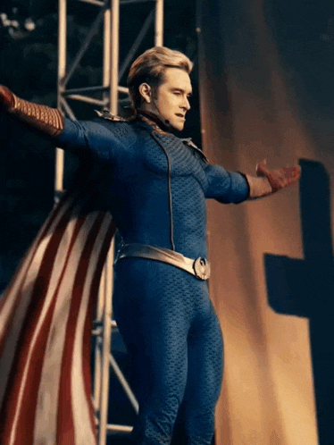 a man in a superhero costume is standing with his arms outstretched
