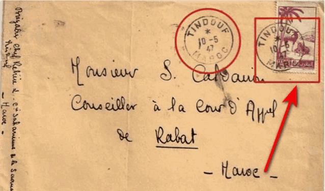an envelope addressed to s. calvain has a red arrow pointing to it