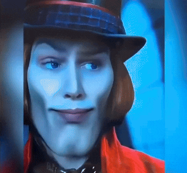 a close up of a man wearing a top hat and red jacket