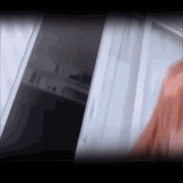 a woman with red hair is standing in a doorway