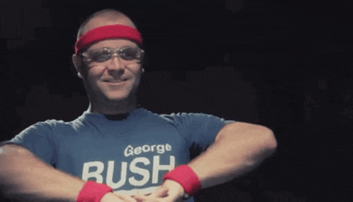 a man wearing a blue george rush shirt