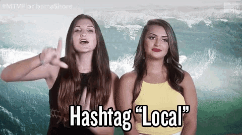 two women are standing next to each other and one of them is saying hashtag " local "