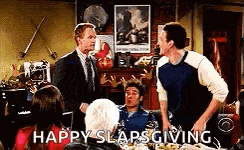 a group of people are sitting at a table with the words happy slaps giving on the bottom .