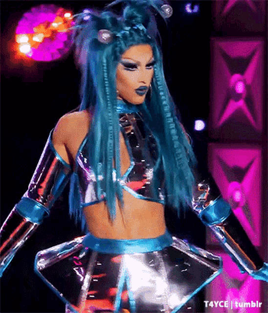 a drag queen with blue hair is wearing a futuristic costume