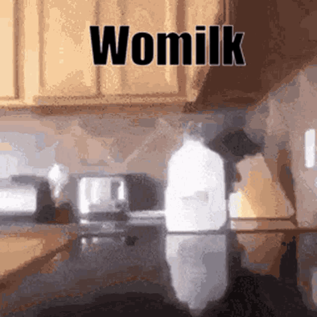 a bottle of womilk is sitting on a kitchen counter