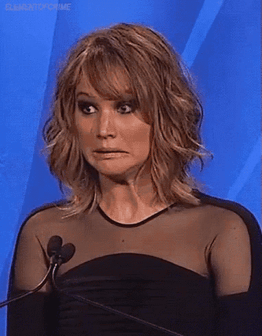 a woman is making a funny face in front of a microphone .