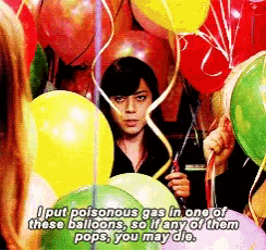 a woman is surrounded by balloons and says i put poisonous gas in one
