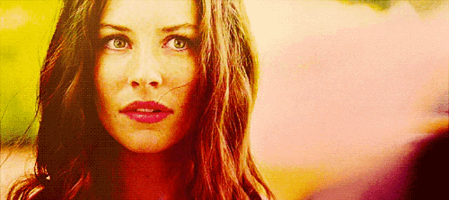 a close up of a woman 's face with a pink lip