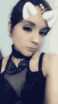 a woman wearing a choker and a crown on her head .