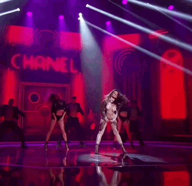 a group of dancers perform on a stage with the word channel behind them