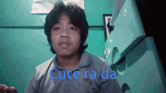 a young man wearing a shirt that says cute ra da on it