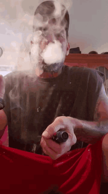 a man smoking a cigarette with smoke coming out of his face