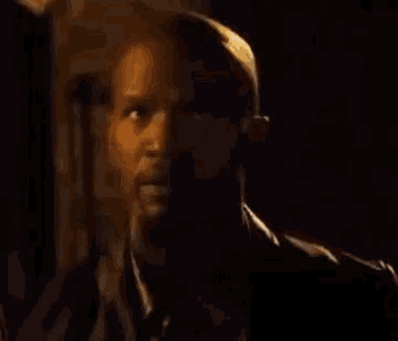 a close up of a man 's face in a dark room .
