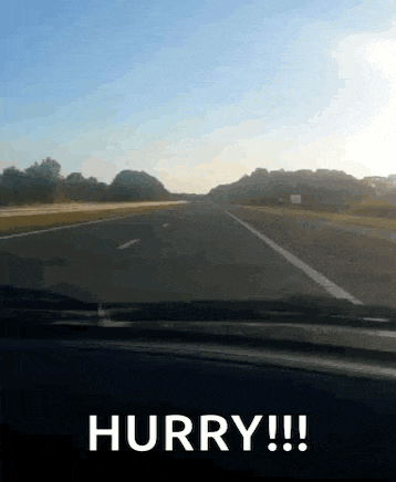 a car is driving down a highway with the words hurry written on the side of the road .