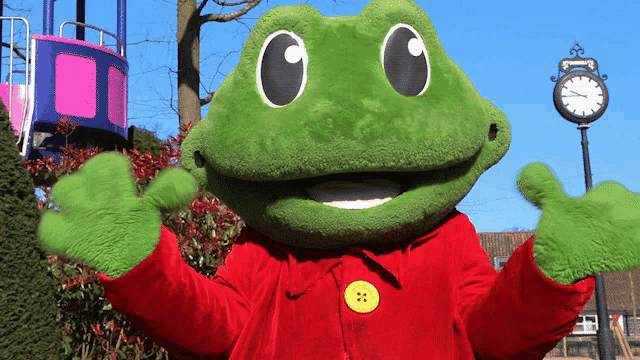 a green frog mascot is standing in front of a clock that shows the time as 4:20