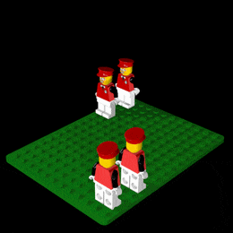 a group of lego figures standing on a green mat