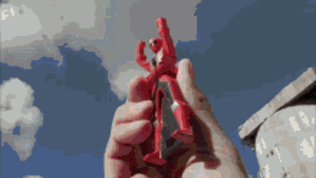 a pixelated image of a person holding a toy