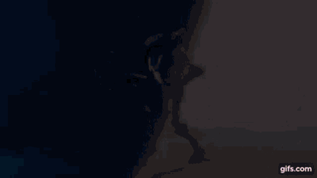 a robot is swimming in the water with a gun .