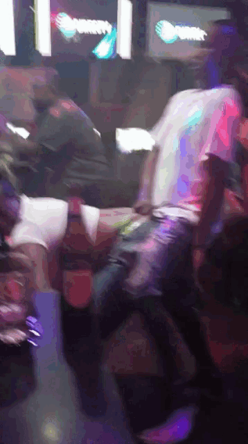 a blurry photo of people dancing in a club with a sign that says sprint