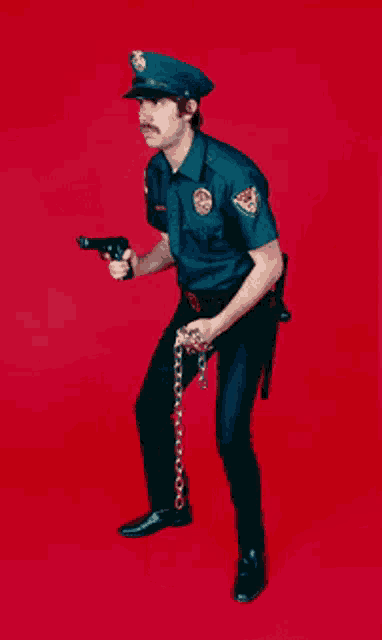 a police officer is holding a gun and a chain in front of a red background