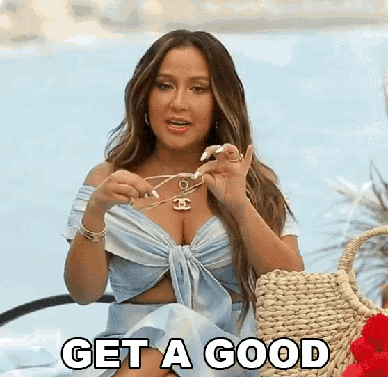 a woman in a blue dress is holding a pair of sunglasses and says get a good .