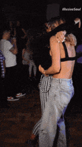 two women are hugging in a dark room with the words illusive soul on the bottom left