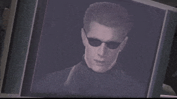 a man wearing sunglasses and a black turtleneck is displayed on a computer screen