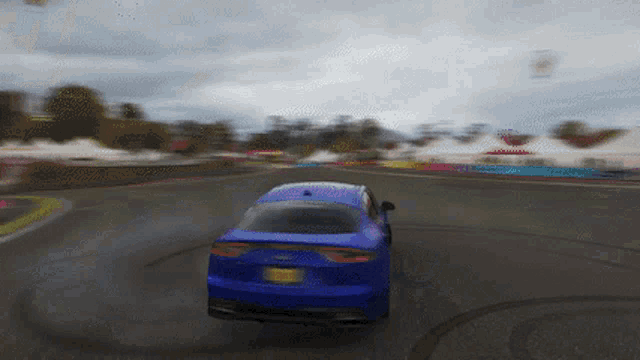 a blue car with a new york license plate is driving on a road
