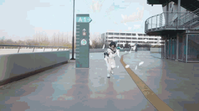 a person running in front of a blue sign that says a1