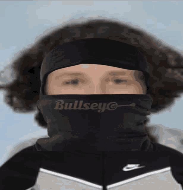 a person wearing a black mask that says bullsey