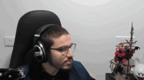 a man wearing headphones and glasses looks at something