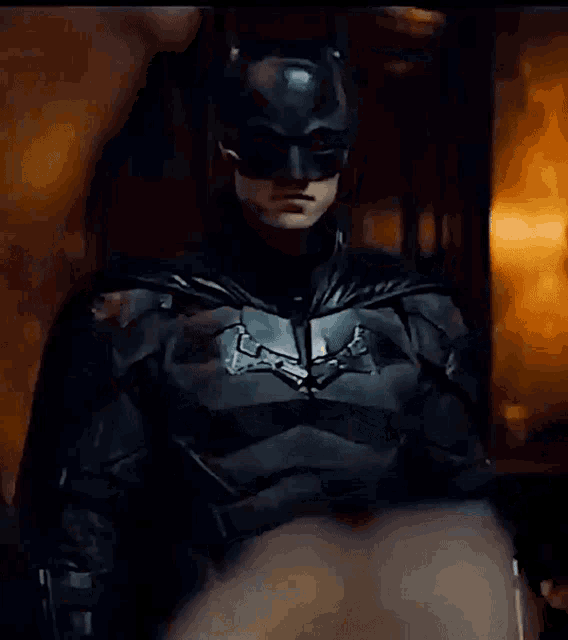 a close up of a man in a batman suit and mask