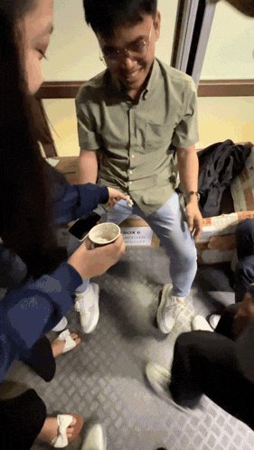 a group of people are sitting around a box that says box 6 on it