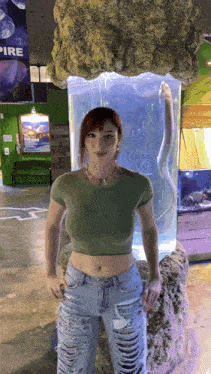 a woman standing in front of an aquarium with a sign that says pire