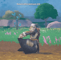 a man in armor is walking through a field of flowers