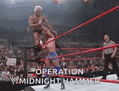 two men are wrestling in a wrestling ring with the words `` operation midnight hammer '' written above them .