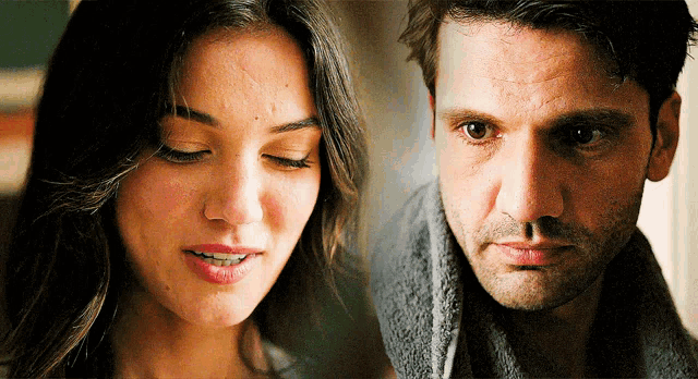 a woman and a man are looking at each other