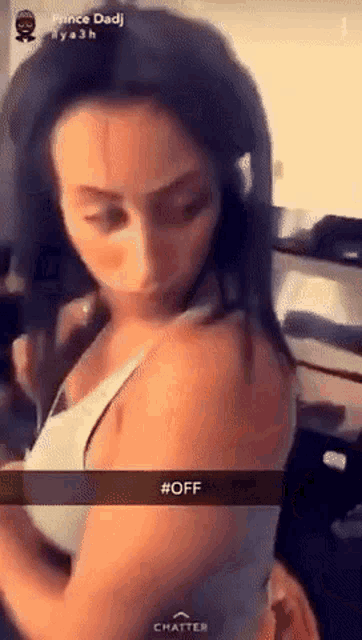 a woman in a white tank top has #off written on the bottom