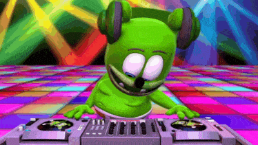 a gummy bear wearing headphones is playing music on a dj mixer