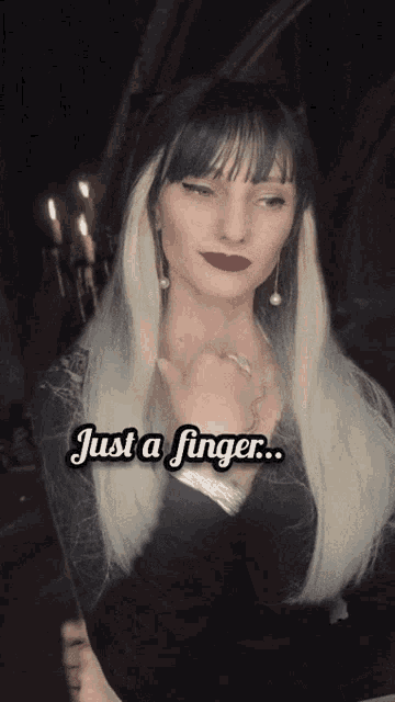 a woman with long blonde hair says " just a finger " in white letters
