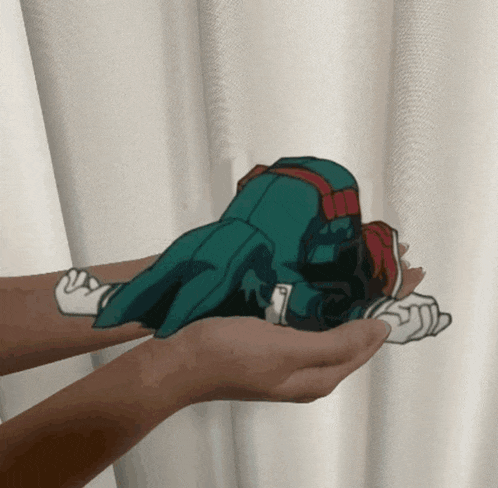 a person is holding a cartoon character in their palms