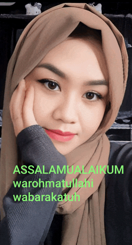 a woman wearing a hijab with the words assalamualaikum warohmatullahi wabarakatuh on the bottom