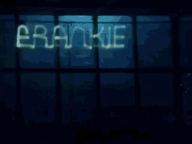 a neon sign that says hollywood is lit up at night