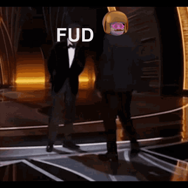 a man in a tuxedo is dancing on a stage with fud written on the bottom