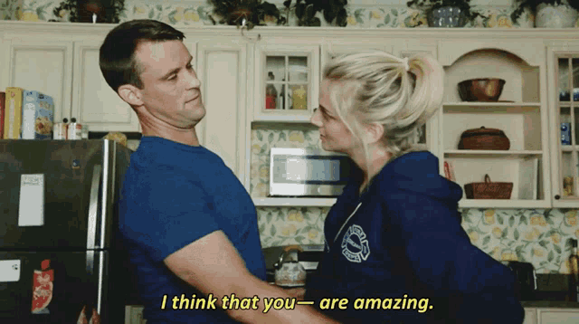 a man holds a woman in his arms and says " i think that you - are amazing "