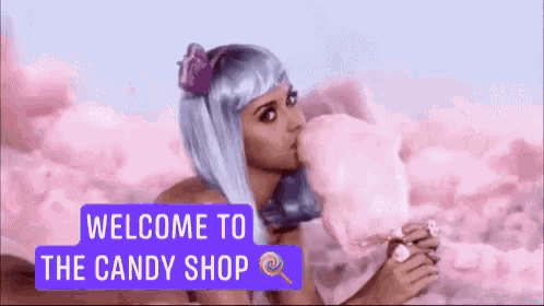 a woman blowing cotton candy with the words welcome to the candy shop behind her