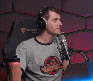 a man is wearing headphones and a shirt that says jurassic park
